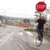 man on bicycle waving hello